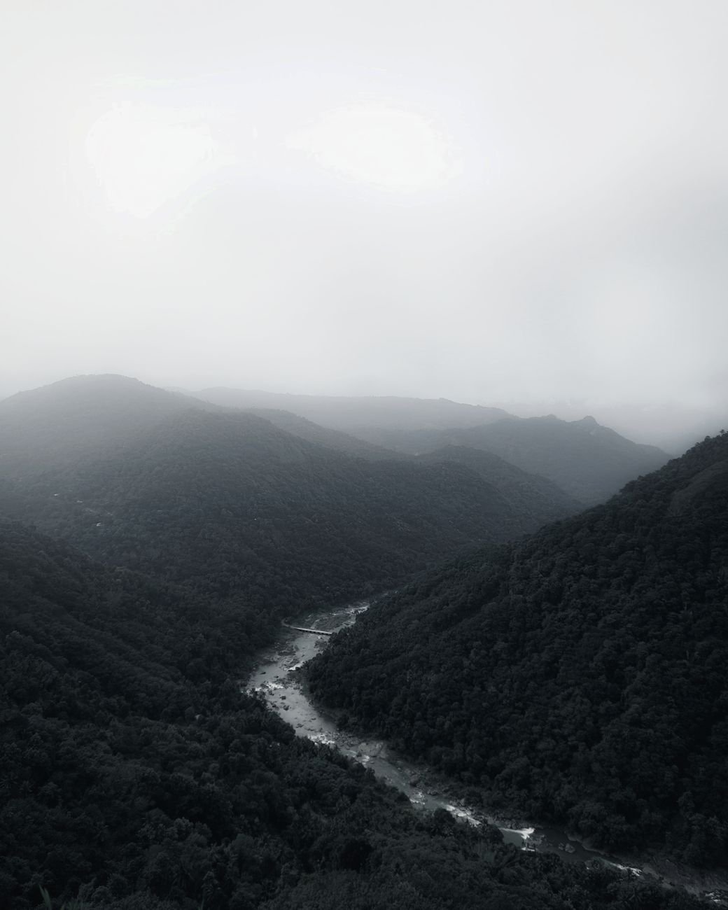 aerial view of mountains and river in the valley