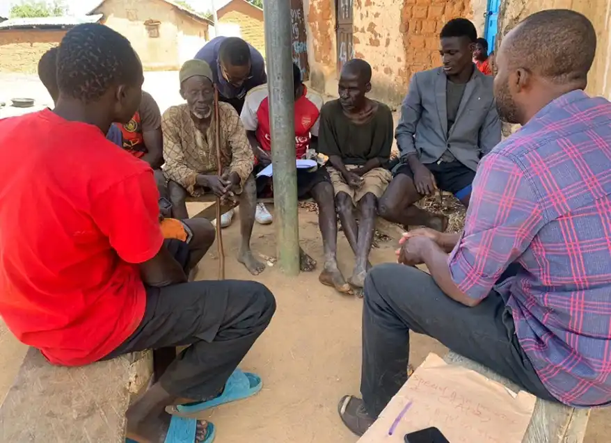 A group of farmers engaged in a discussion under a shade in a rural community, sharing knowledge and experiences related to climate adaptation.In my study, “Analysis of Indigenous Communication Approaches for Climate Change Mitigation and Adaptation among Rural Farmers in FCT-Abuja, Nigeria,” published in the Lokoja Journal of Information Science Research, I explored how six rural communities in Nigeria’s Federal Capital Territory (FCT) are responding to the climate crisis through long-standing indigenous knowledge systems.