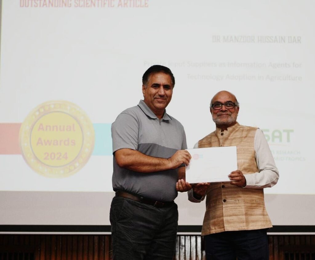 Dr. Manzoor Hussain Dar receiving an award for Outstanding Scientific Article at the Annual Awards 2024 event, standing alongside another individual.