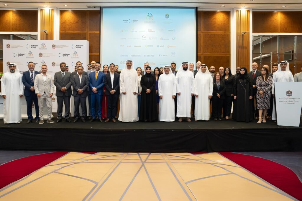 Group photo of officials and representatives from the Ministry of Climate Change and Environment and Tadweer Group during the signing of a Memorandum of Understanding for a waste management pilot project.