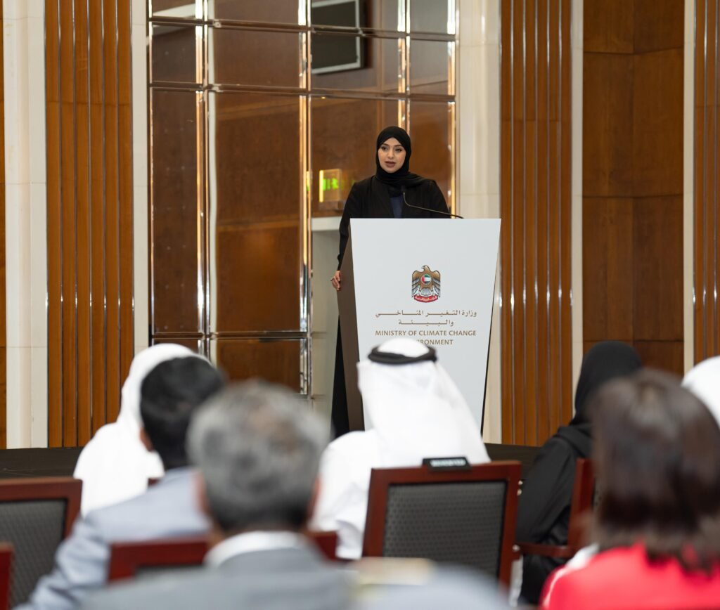 Her Excellency Dr. Amna bint Abdullah Al Dahak speaking at the event for the Memorandum of Understanding signing between the Ministry of Climate Change and Environment and Tadweer Group, with attendees visible in the foreground.