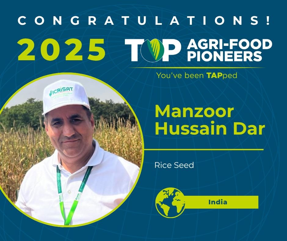A professional headshot of Manzoor Hussain Dar, wearing a white cap with ICRISAT branding, standing in front of a field. The image features a congratulatory message about his recognition as a 2025 Top Agri-Food Pioneer in India.