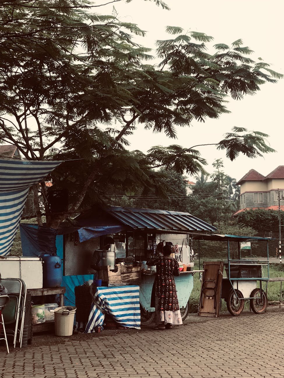 a street vendor selling food on a sidewalk