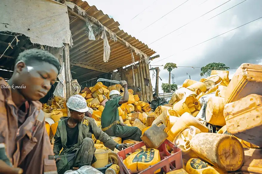 Workers sorting yellow plastic containers in a recycling facility in Mombasa, Kenya.