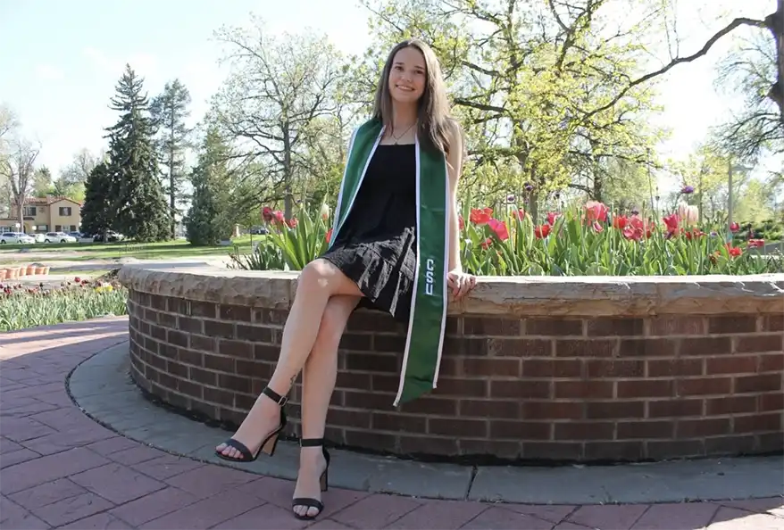 A smiling woman in a black dress and green graduation sash sits on a brick wall surrounded by colorful tulips and trees in a park.Emily Billow grew up in Longmont, Colorado, and graduated from CSU in 2024 with a bachelor’s degree in biological science. During her time as an undergraduate, she worked in the Doubled Haploid Lab, where she conducted research on the effectiveness of different plant growth regulators in generating viable embryos. Currently, she is pursuing a master’s degree in plant breeding and genetics working as a Graduate Research Assistant under Dr. Esten Mason. In this role, she focuses on molecular breeding research aimed at developing resistance to Fusarium Head Blight in the CSU Wheat Breeding Program. Her interests include plant pathology, bioinformatics, and systematic biology, with a passion for using molecular techniques to enhance crop resistance to pests and diseases. This passion is driven by her fascination with insects and fungi, particularly discovering or engineering biological control agents to be used in integrated pest management strategies. She aspires to engage in interdisciplinary research that combines plant breeding with biotechnology, ecology, and molecular genetics.