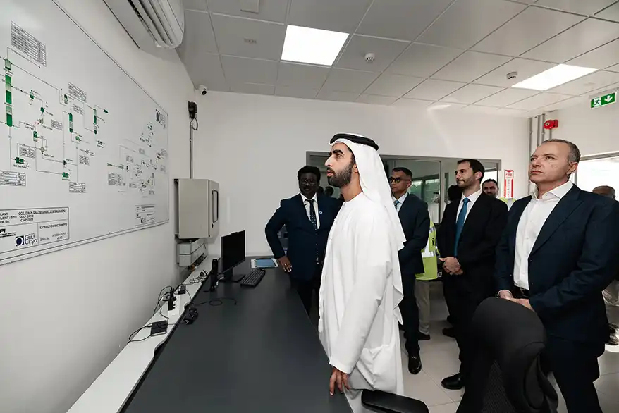Group of professionals observing a control panel displaying the carbon capture process at the Gulf Cryo facility in Ras Al Khaimah.