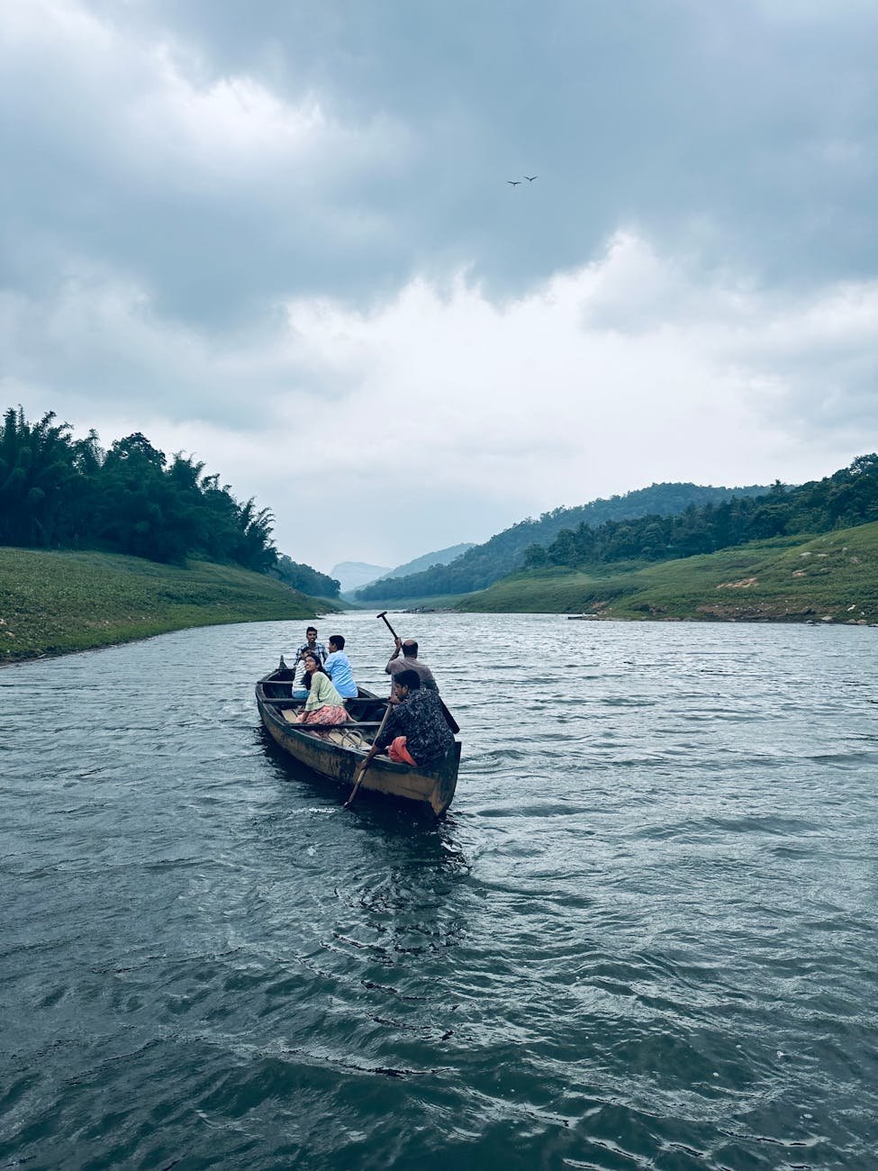 a group of people are riding in a boat on a river