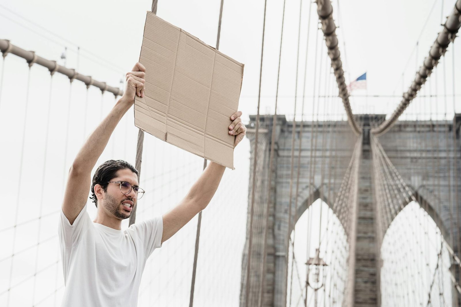 a man with a blank placard raised above his head