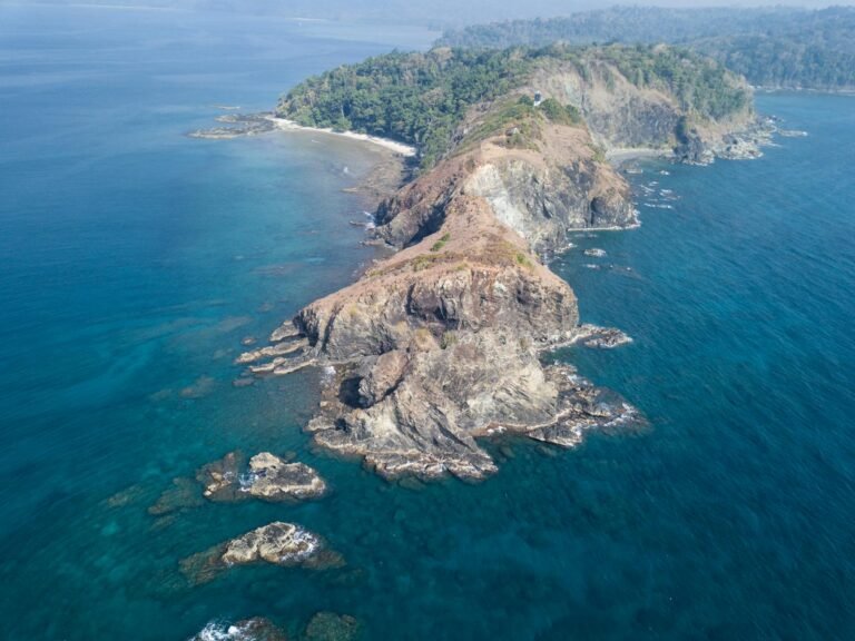 aerial photography of a cliff surrounded with body of water