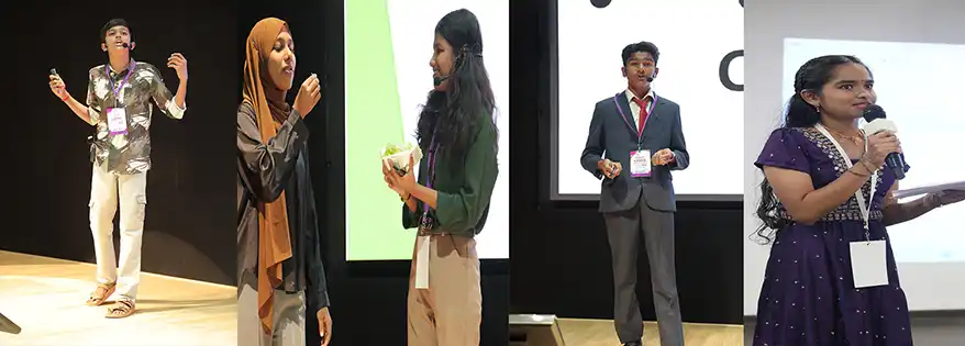 A young male speaker presenting passionately on stage.