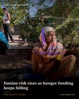 Elderly woman sitting outdoors beside grain-filled bowls in a village setting