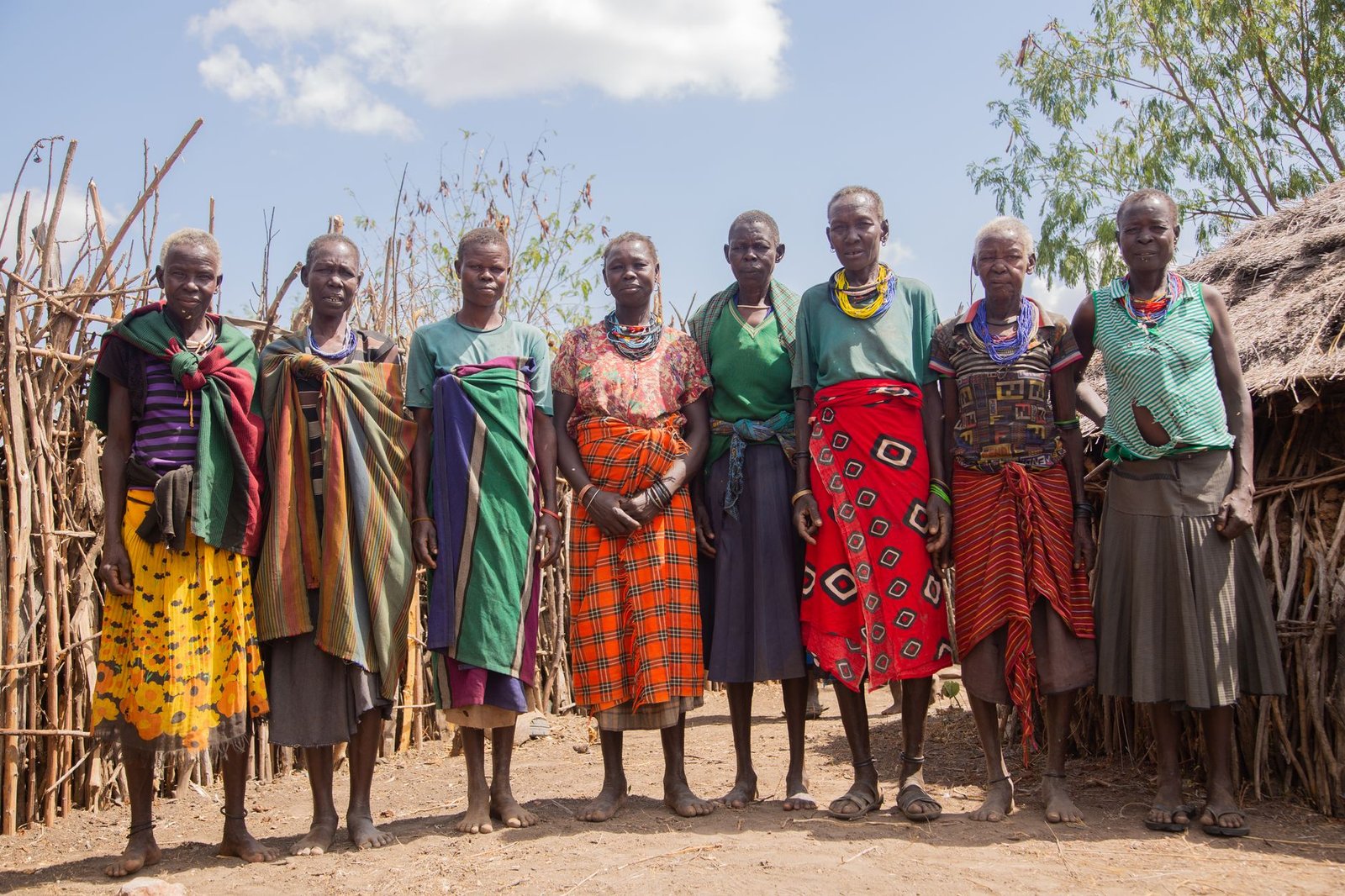 group of women next to a hut in an african village