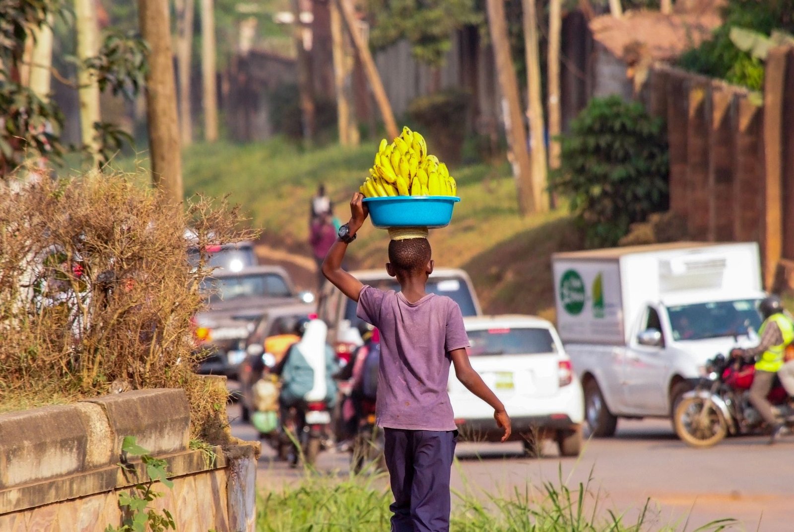 street vendor carrying bananas in kampala