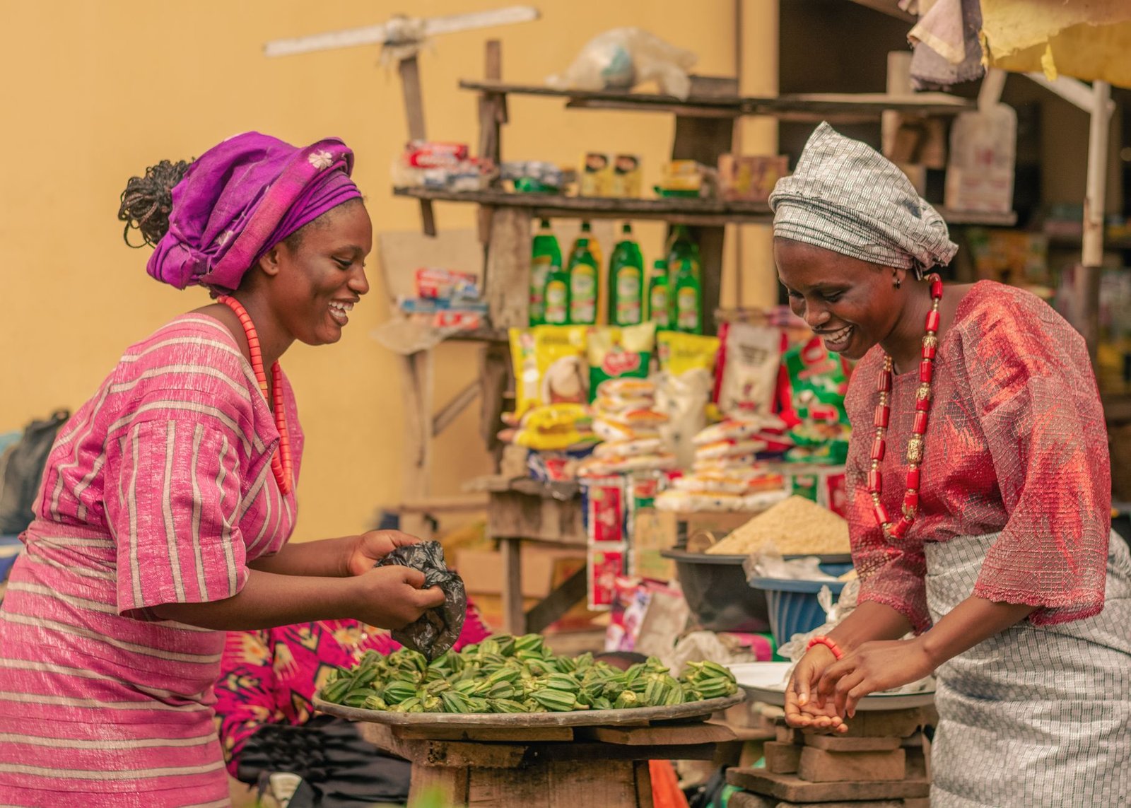 women engaging in lively market exchange outdoors