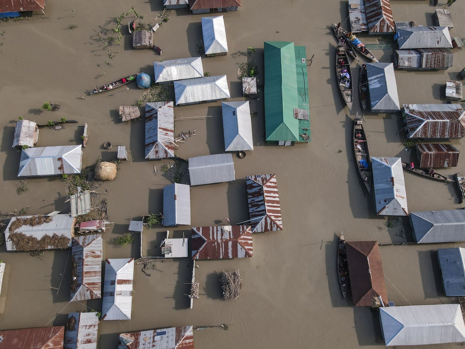 aerial view of flooded village with tin roofs