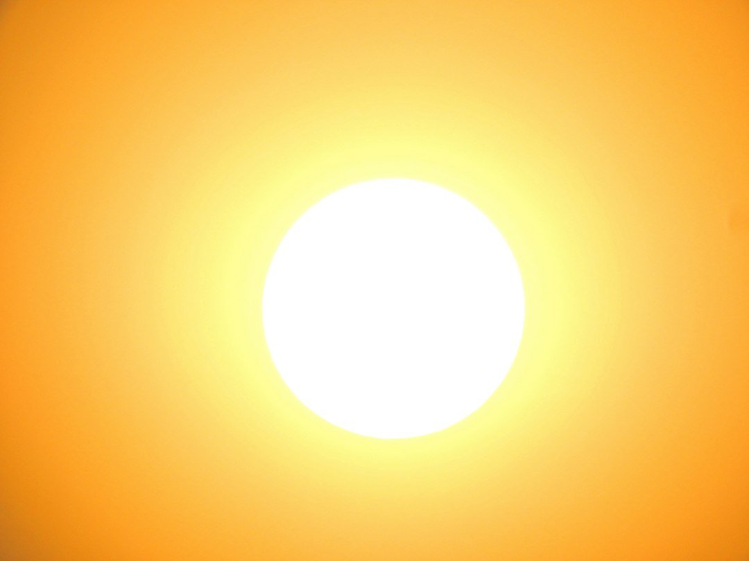 Bright white sun in an orange sky