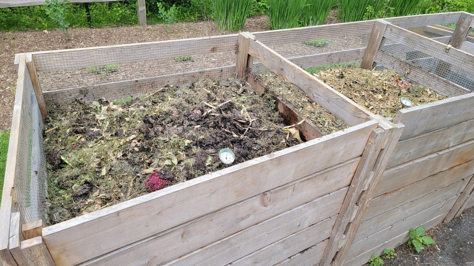 Wooden compost bins filled with organic matter
