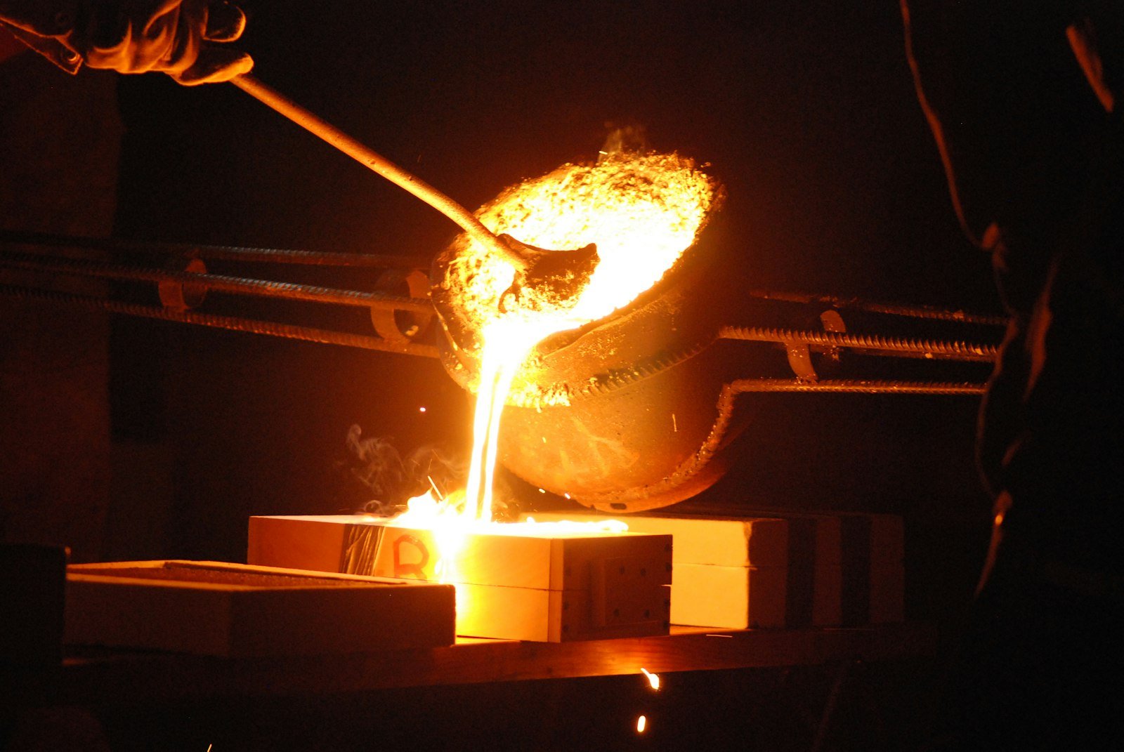Artisan working on a piece of cast metal