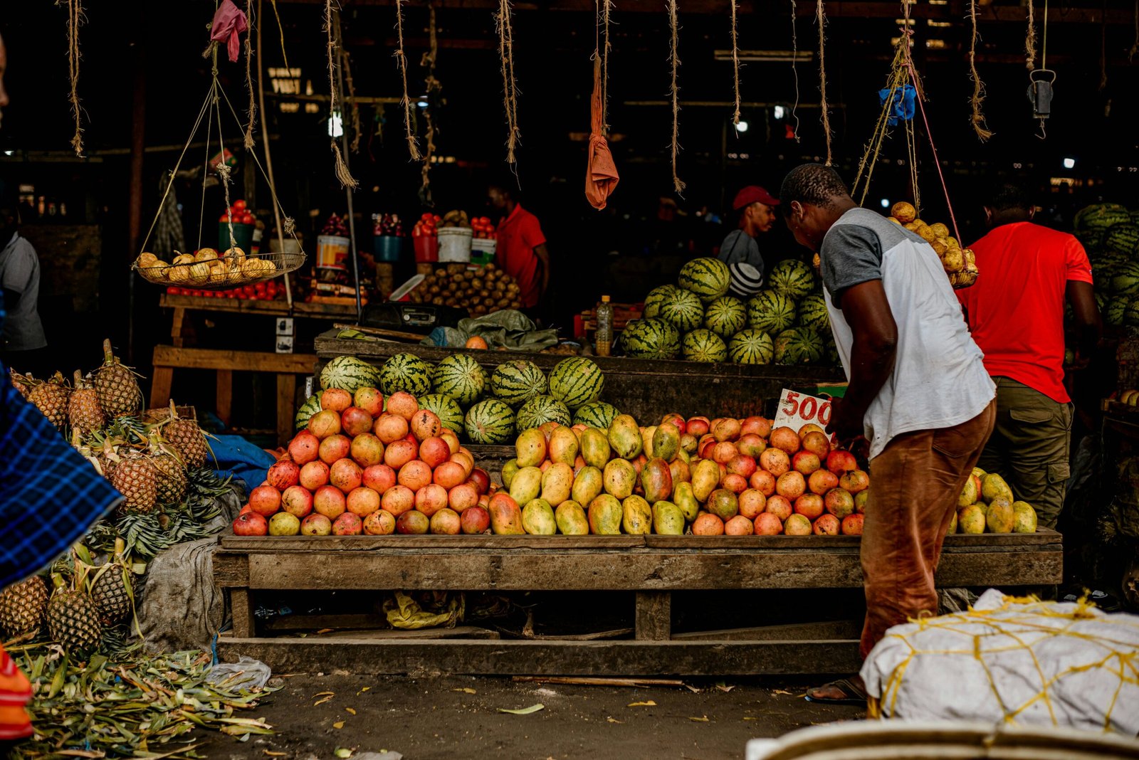 A vendor at a local African fruit and vegetable market