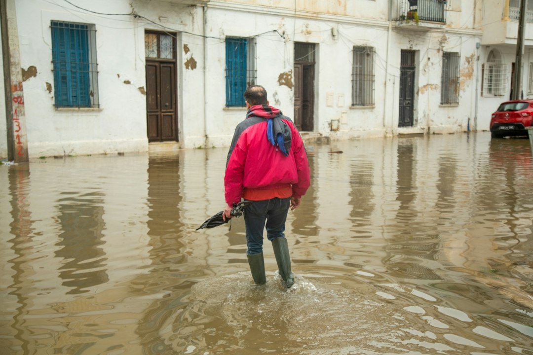 A man wades through a flooded street