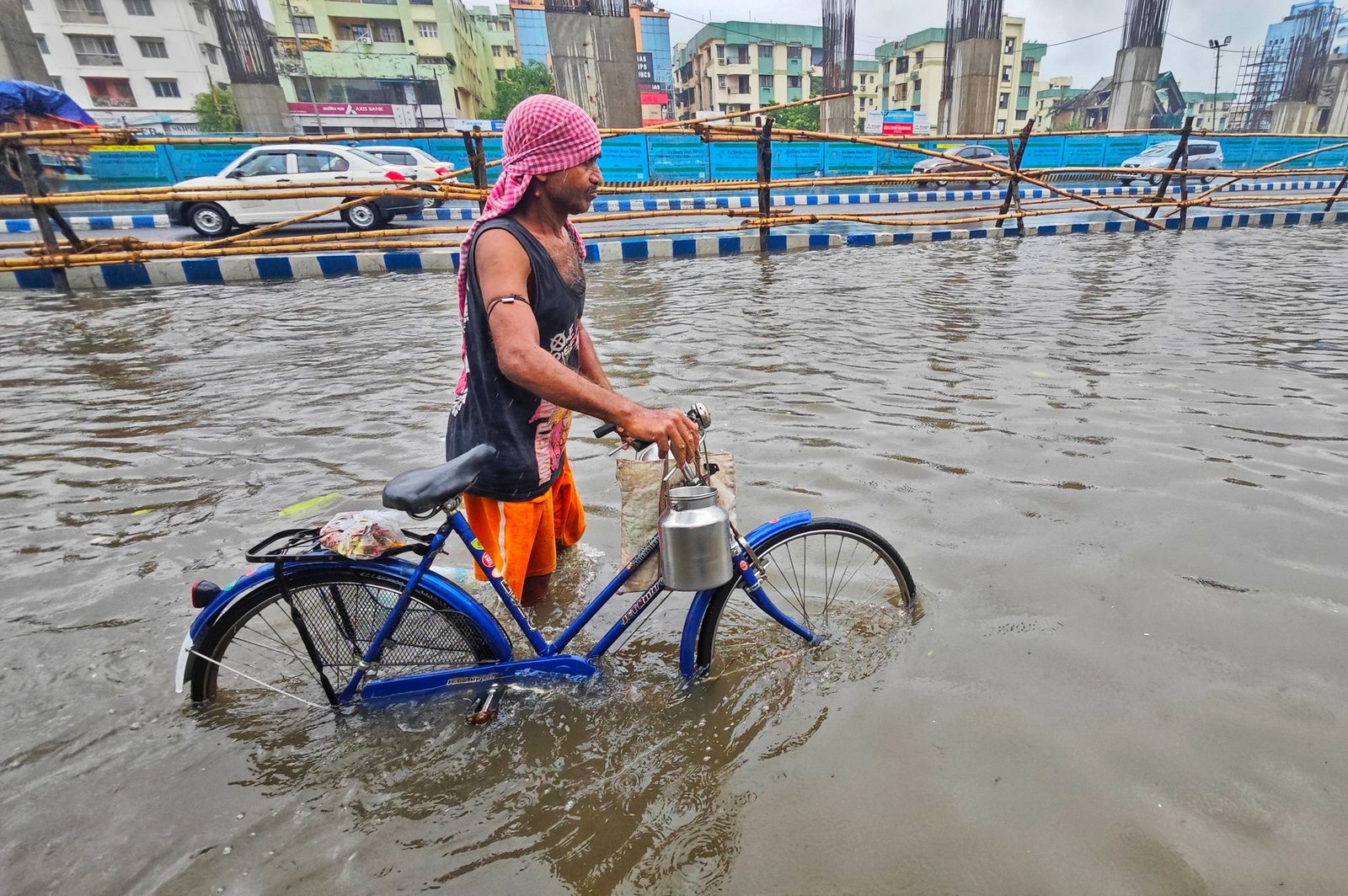 a man with a bicycle in water