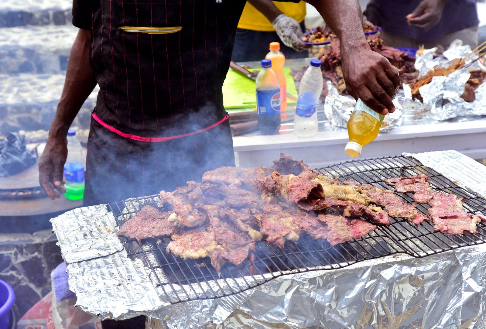 a man is cooking meat on a grill