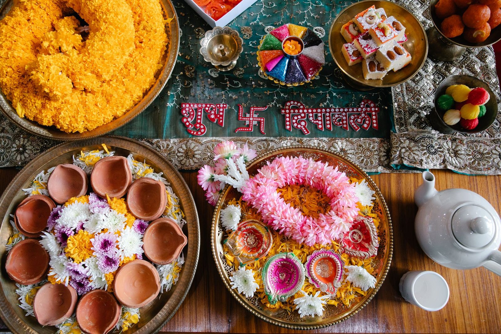 a festive decorations of flowers on plates with bowls of assorted sweets