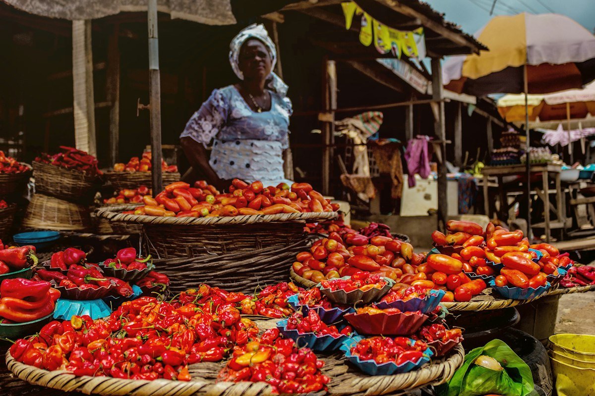 A vendor selling produce at a market in Nigeria