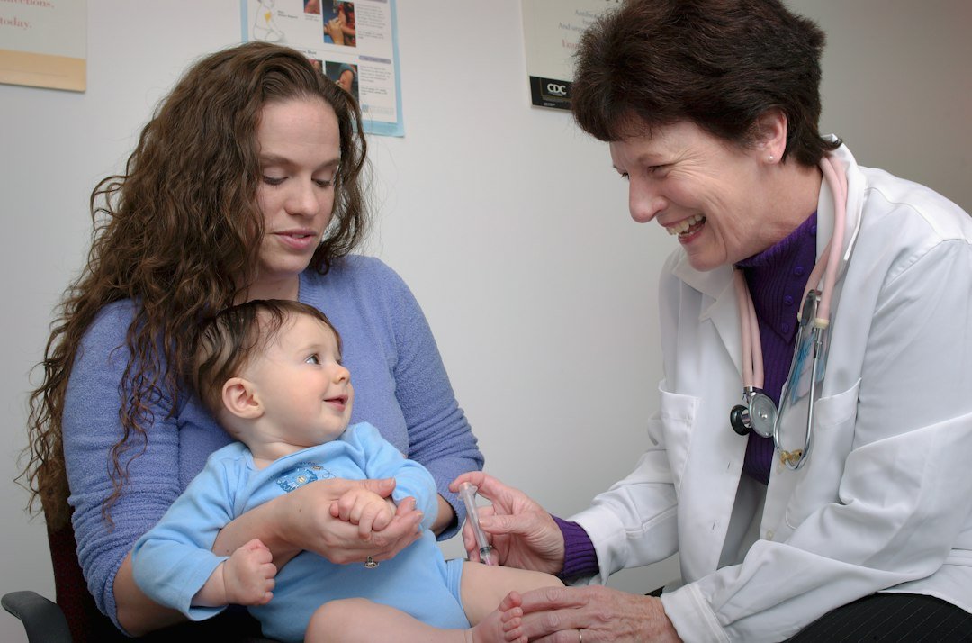 A paediatrician examines a young child at a clinic