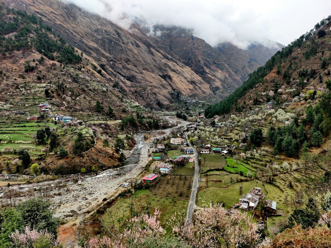 A village in the middle of a valley surrounded by mountains
