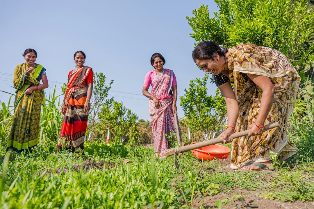 A group of women farmers standing together in a field in India