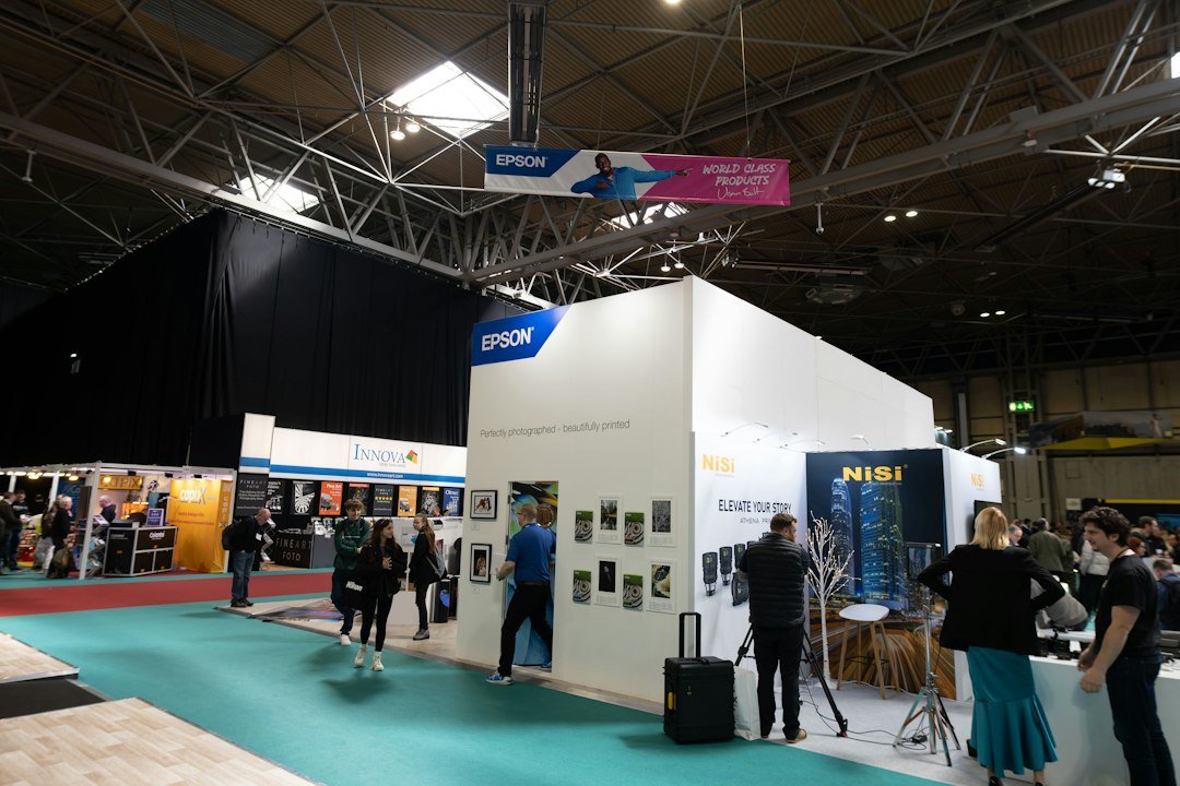 A group of people standing around a trade show booth