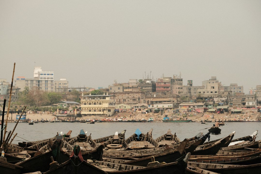 A cluster of wooden fishing boats on the Buriganga River in Dhaka, Bangladesh