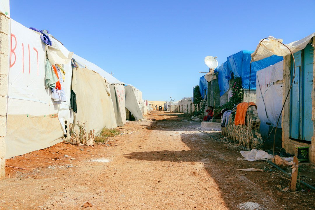 Dirt road lined with tents and shacks