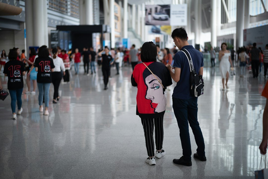 Visitors walking through a large modern convention centre