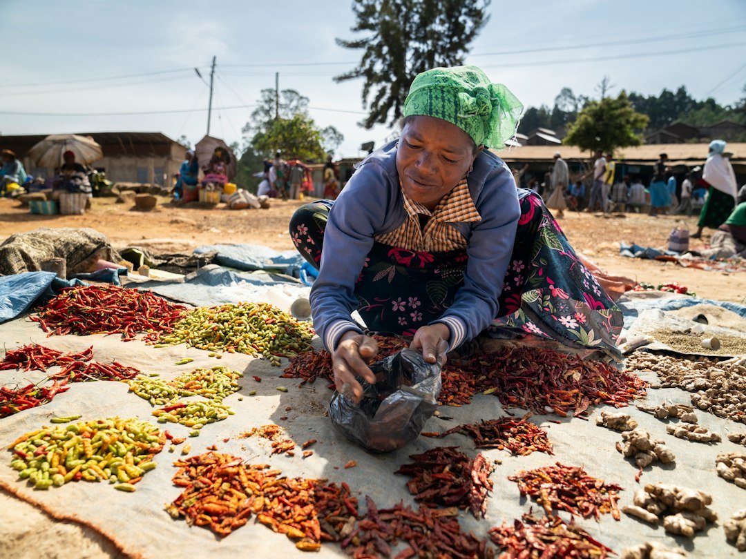 A woman selling spices at an outdoor market