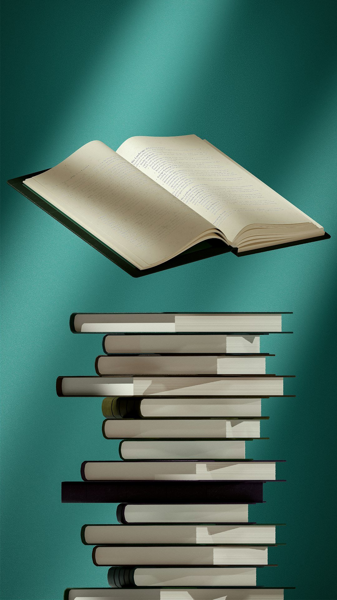 An open book resting on top of a stack of books
